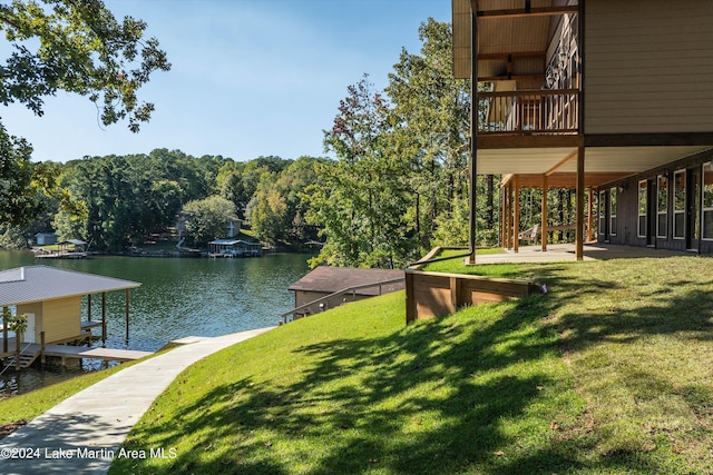 exterior space with a water view, boat lift, a patio, and a boat dock