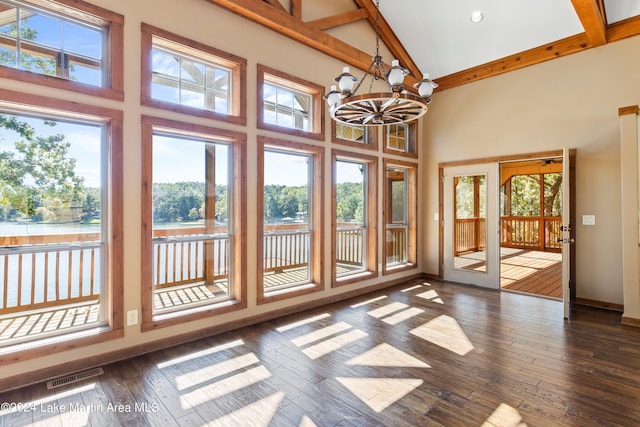 unfurnished sunroom featuring beam ceiling, visible vents, an inviting chandelier, and a water view