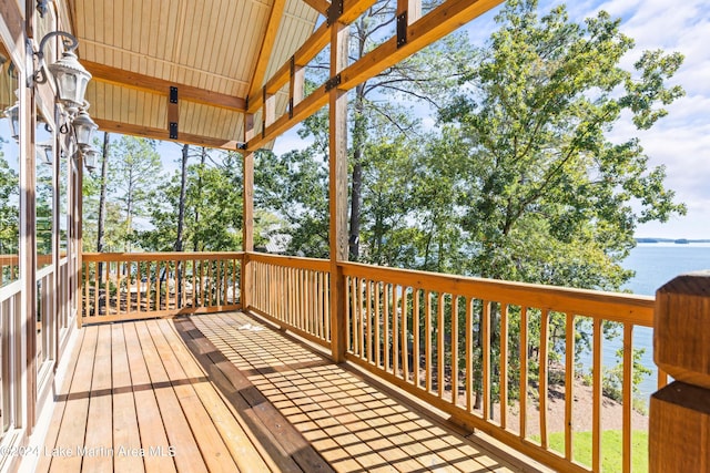 wooden terrace featuring a water view