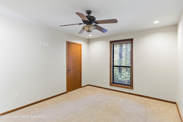 carpeted spare room featuring a ceiling fan, recessed lighting, and baseboards