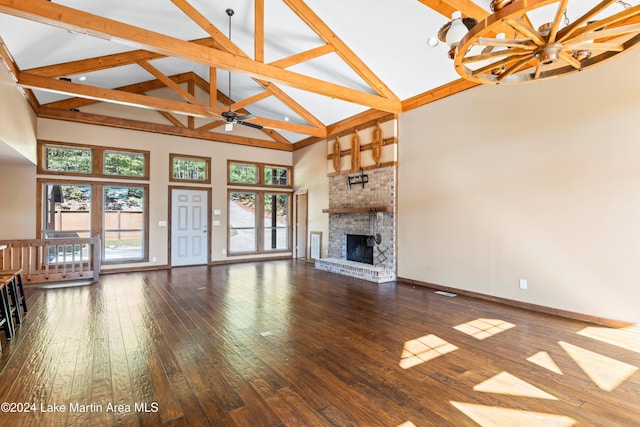 unfurnished living room featuring a brick fireplace, baseboards, hardwood / wood-style floors, high vaulted ceiling, and a ceiling fan