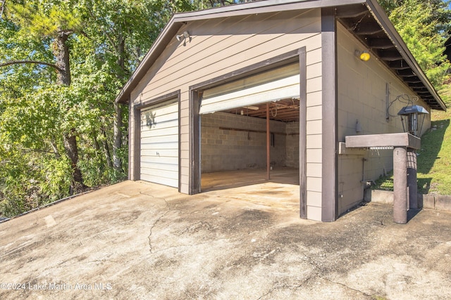 garage featuring concrete driveway