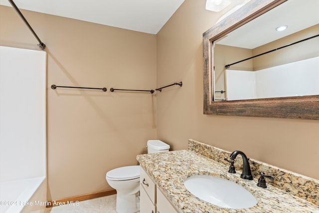 bathroom with vanity, toilet, baseboards, and tile patterned flooring