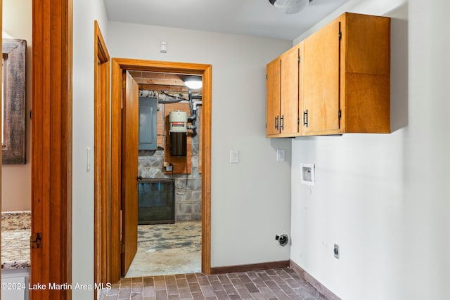 clothes washing area with washer hookup, electric panel, cabinet space, and baseboards