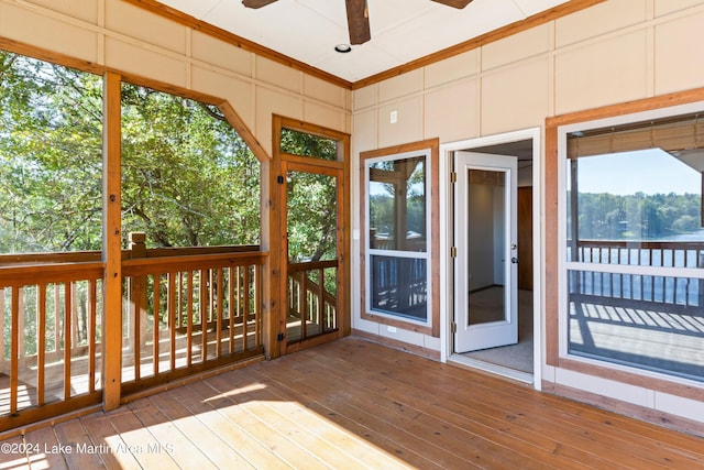 unfurnished sunroom featuring ceiling fan