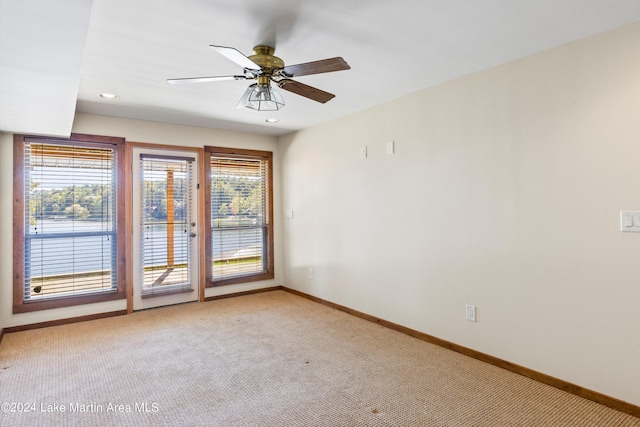 empty room with recessed lighting, baseboards, light colored carpet, and a healthy amount of sunlight