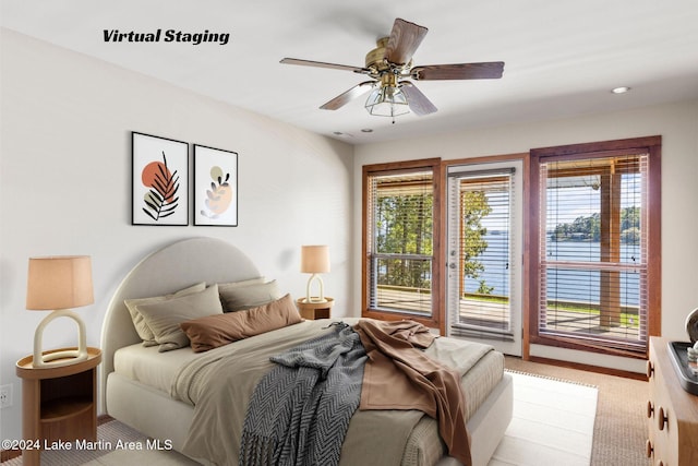 bedroom featuring multiple windows, light carpet, access to exterior, and a ceiling fan