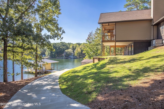 exterior space with a lawn and a water view