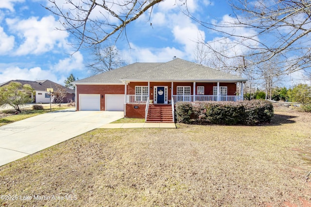 ranch-style house featuring a porch, a garage, and a front yard