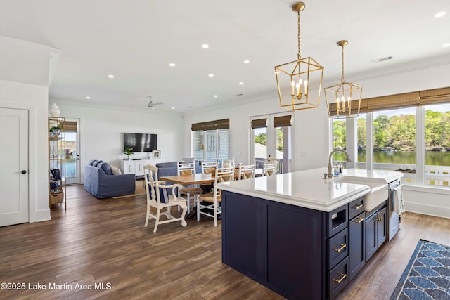 302 Williams Rd, Alexander City, AL 35010 - kitchen featuring dark wood-style flooring, ornamental molding, light countertops, visible vents, and a sink