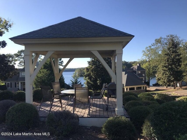 view of patio featuring a gazebo and a water view