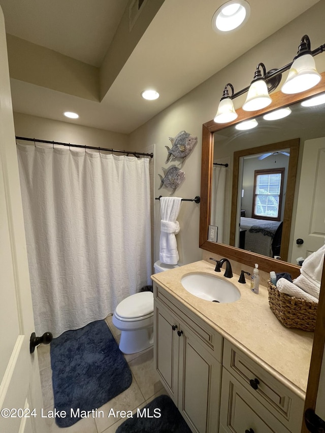 bathroom featuring tile patterned flooring, vanity, and toilet