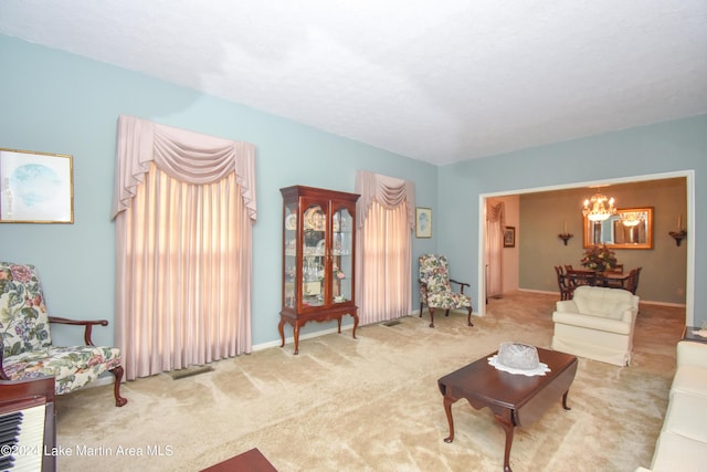 living room with light carpet and an inviting chandelier