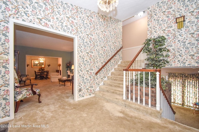 interior space with carpet floors and an inviting chandelier