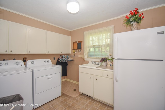 clothes washing area featuring independent washer and dryer, ornamental molding, and sink