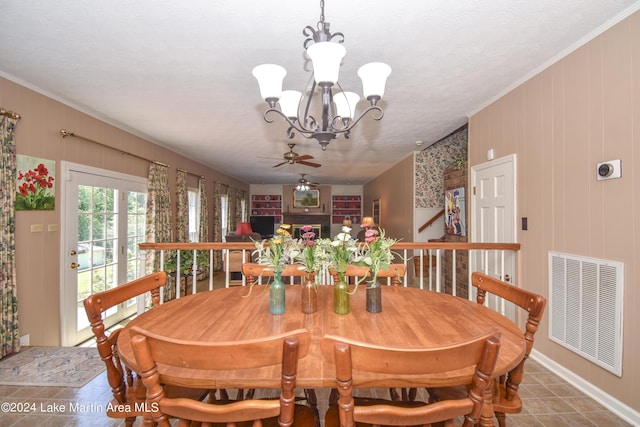 tiled dining space with crown molding and ceiling fan with notable chandelier