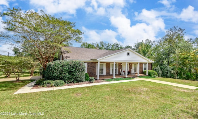 view of front of house with a porch and a front lawn