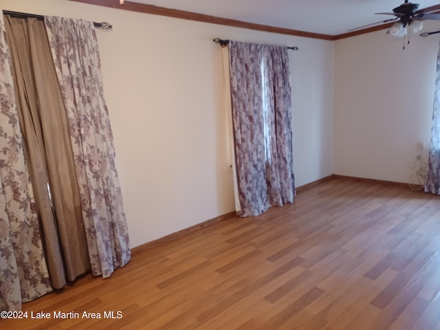 spare room with ceiling fan, light hardwood / wood-style flooring, and ornamental molding