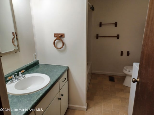 full bathroom with vanity, bathtub / shower combination, and toilet