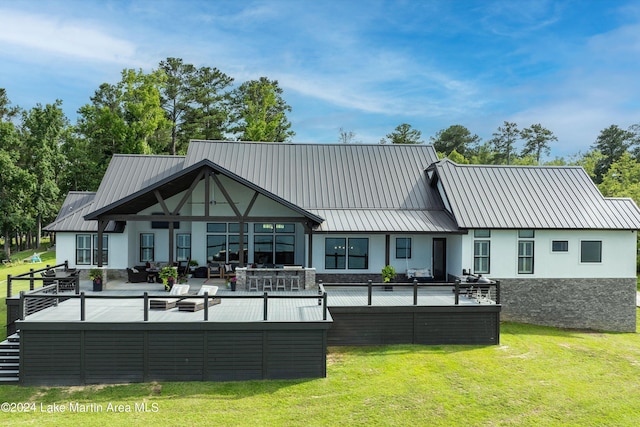 back of house with outdoor lounge area and a yard