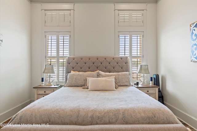 bedroom featuring hardwood / wood-style flooring and multiple windows