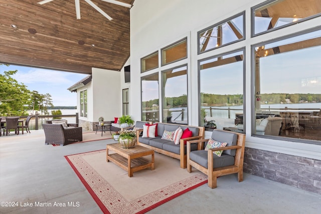 view of patio featuring ceiling fan, a water view, and an outdoor hangout area