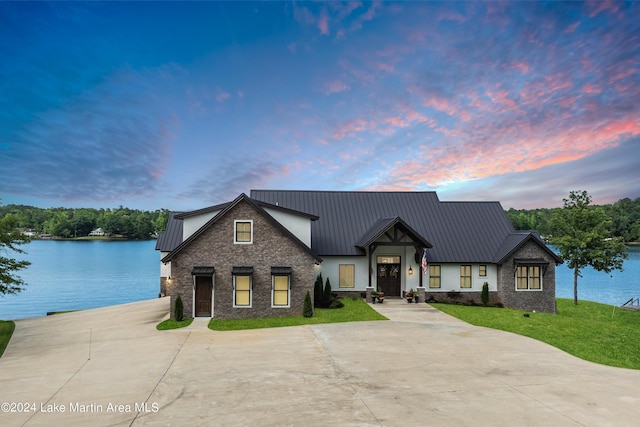 modern farmhouse with a water view and a yard