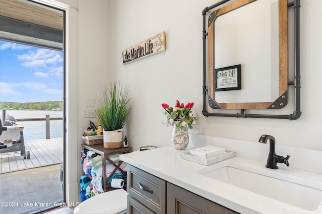 bathroom featuring vanity, toilet, and a water view