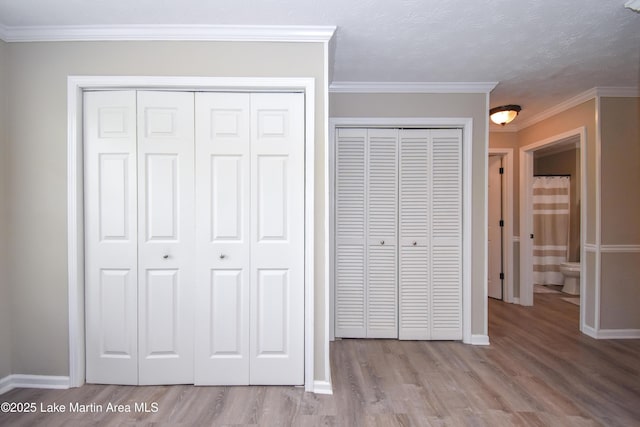 unfurnished bedroom featuring baseboards, ornamental molding, and wood finished floors