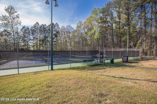 view of sport court featuring a lawn and fence