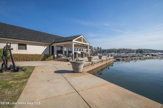 exterior space with a water view and a patio area