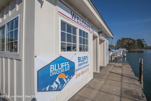 exterior space featuring a boat dock and a water view
