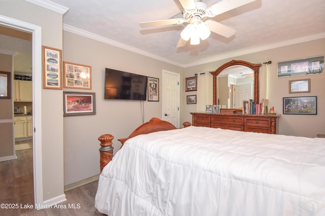bedroom with baseboards, ceiling fan, ornamental molding, and wood finished floors