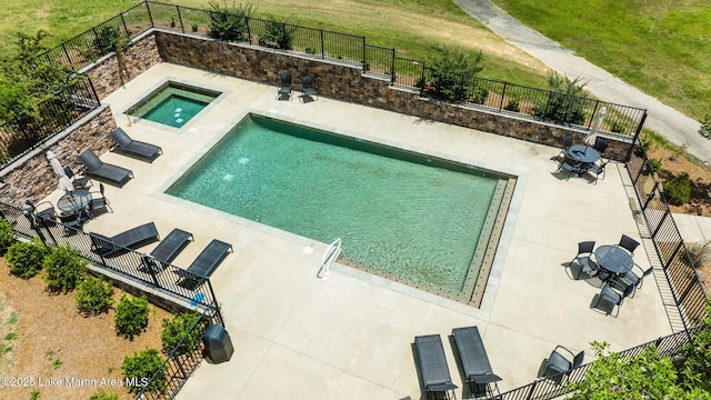 view of swimming pool featuring a fenced backyard, a patio, and a lawn
