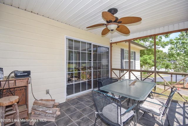 sunroom featuring ceiling fan and outdoor dining space