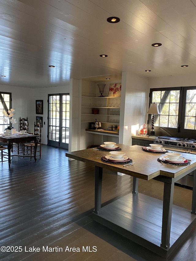 dining space featuring a wealth of natural light and dark wood-type flooring