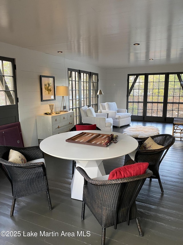 dining space with wood-type flooring and plenty of natural light