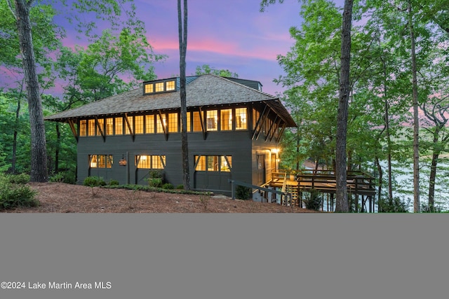 view of back house at dusk