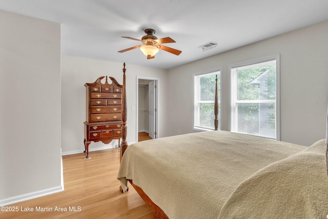 72 Christopher Cir, Alexander City, AL 35010 - bedroom featuring light wood finished floors, a walk in closet, ceiling fan, and a closet