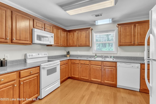 72 Christopher Cir, Alexander City, AL 35010 - kitchen with white appliances, light wood-type flooring, and brown cabinets