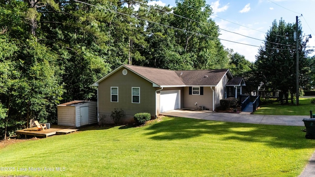 72 Christopher Cir, Alexander City, AL 35010 - view of front of house featuring a storage unit, a garage, driveway, a front lawn, and a deck