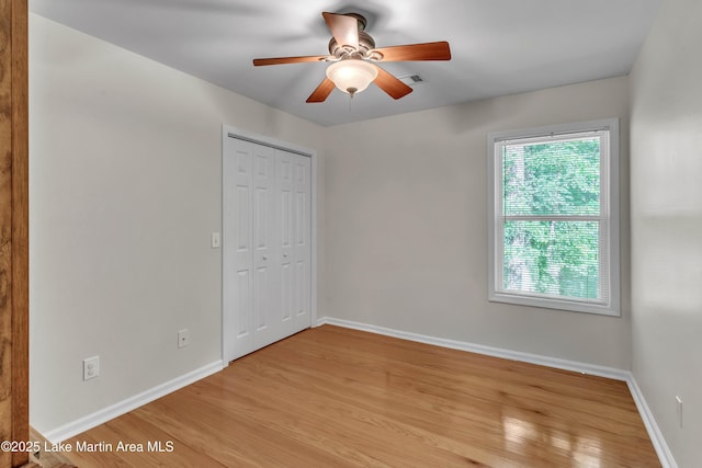 72 Christopher Cir, Alexander City, AL 35010 - unfurnished bedroom with light wood-style flooring, a closet, and ceiling fan