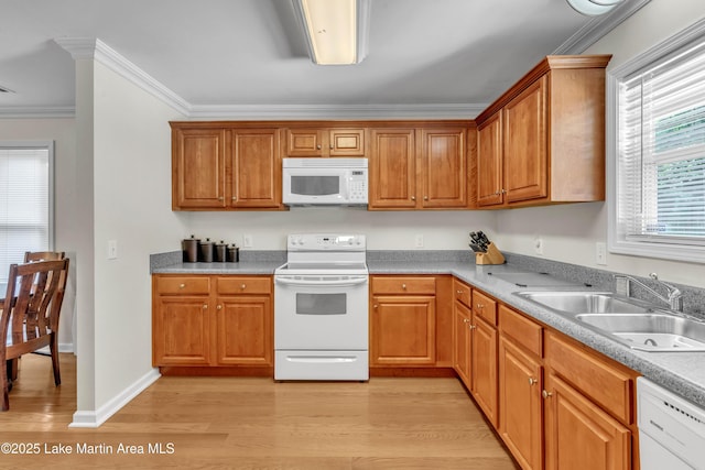 72 Christopher Cir, Alexander City, AL 35010 - kitchen featuring white appliances, light wood finished floors, ornamental molding, brown cabinetry, and light countertops