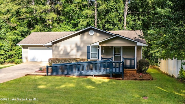 72 Christopher Cir, Alexander City, AL 35010 - view of front of house featuring an attached garage, concrete driveway, covered porch, and a front yard