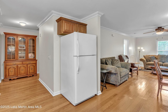 72 Christopher Cir, Alexander City, AL 35010 - kitchen with freestanding refrigerator, light wood-style floors, ceiling fan, ornamental molding, and open floor plan