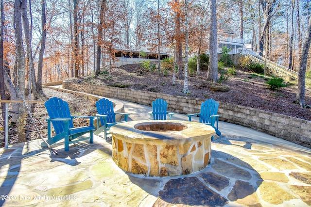 view of patio / terrace with an outdoor fire pit and stairs