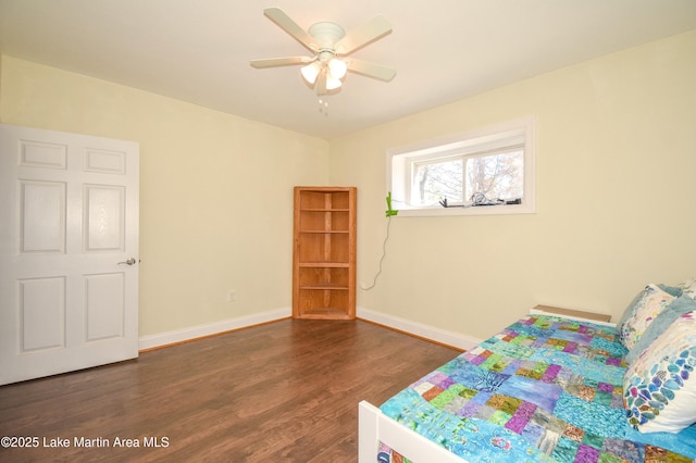 bedroom featuring ceiling fan, baseboards, and wood finished floors