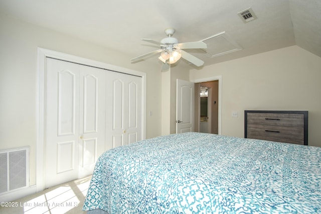 bedroom with ceiling fan, visible vents, a closet, and attic access