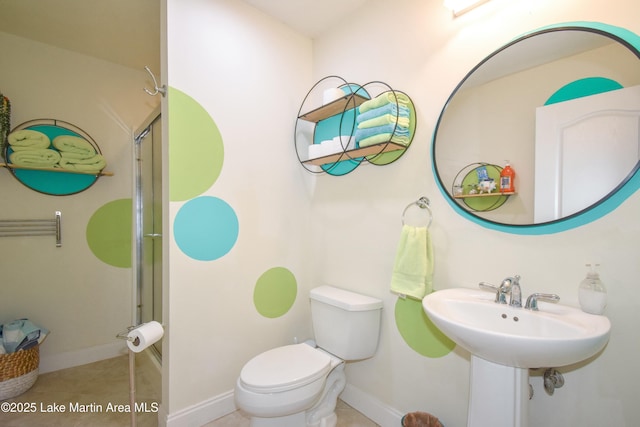 full bathroom with tile patterned floors, baseboards, toilet, and a stall shower