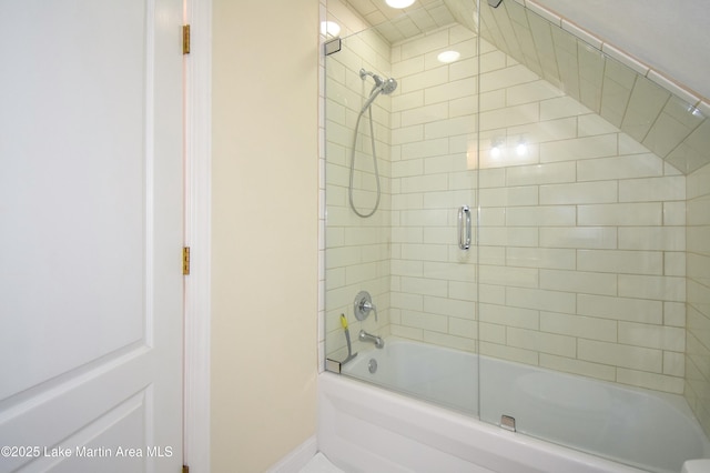 full bath featuring baseboards and shower / bath combination with glass door